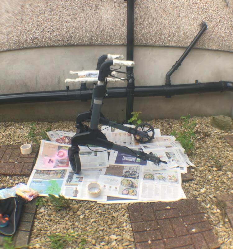 walker with wheels removed placed on newspaper