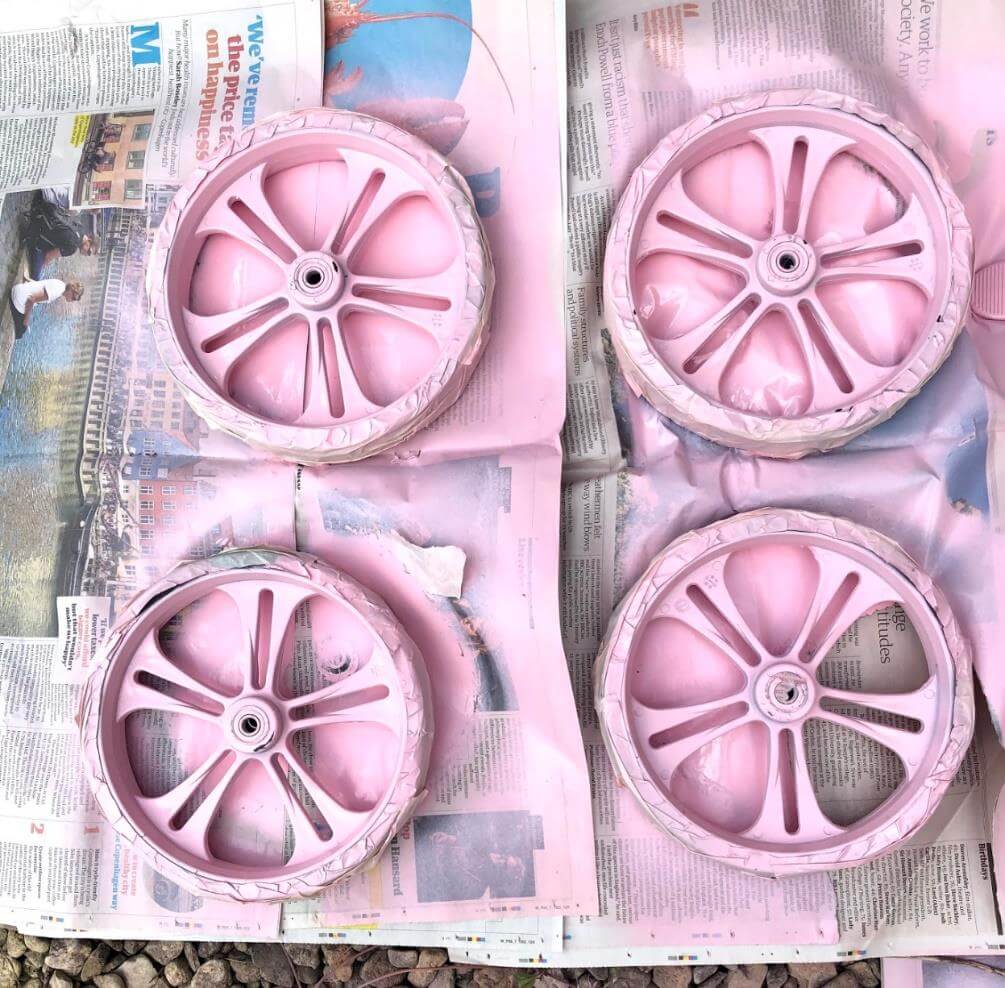 the wheels of the walker have been removed, covered in tape and then sprayed pink