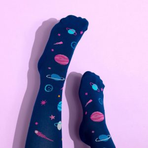 Dark navy space design compression socks on a lilac background