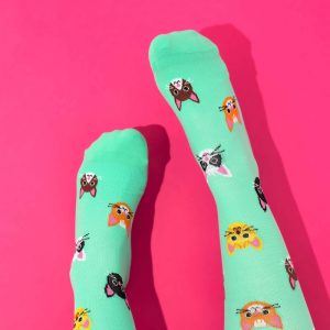 Green cat compression socks on pink background