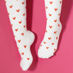 White compression socks with red heart print on them